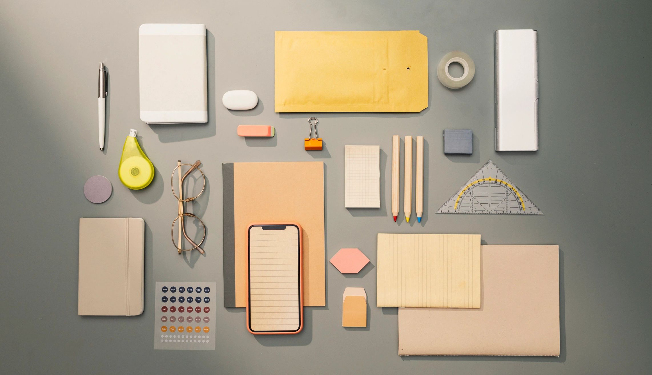 Flat lay of office-related objects and supplies on a desk